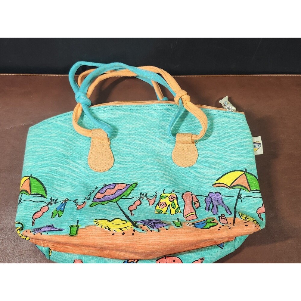 Sally Huss beach tote featuring a colorful, whimsical beach scene with umbrellas